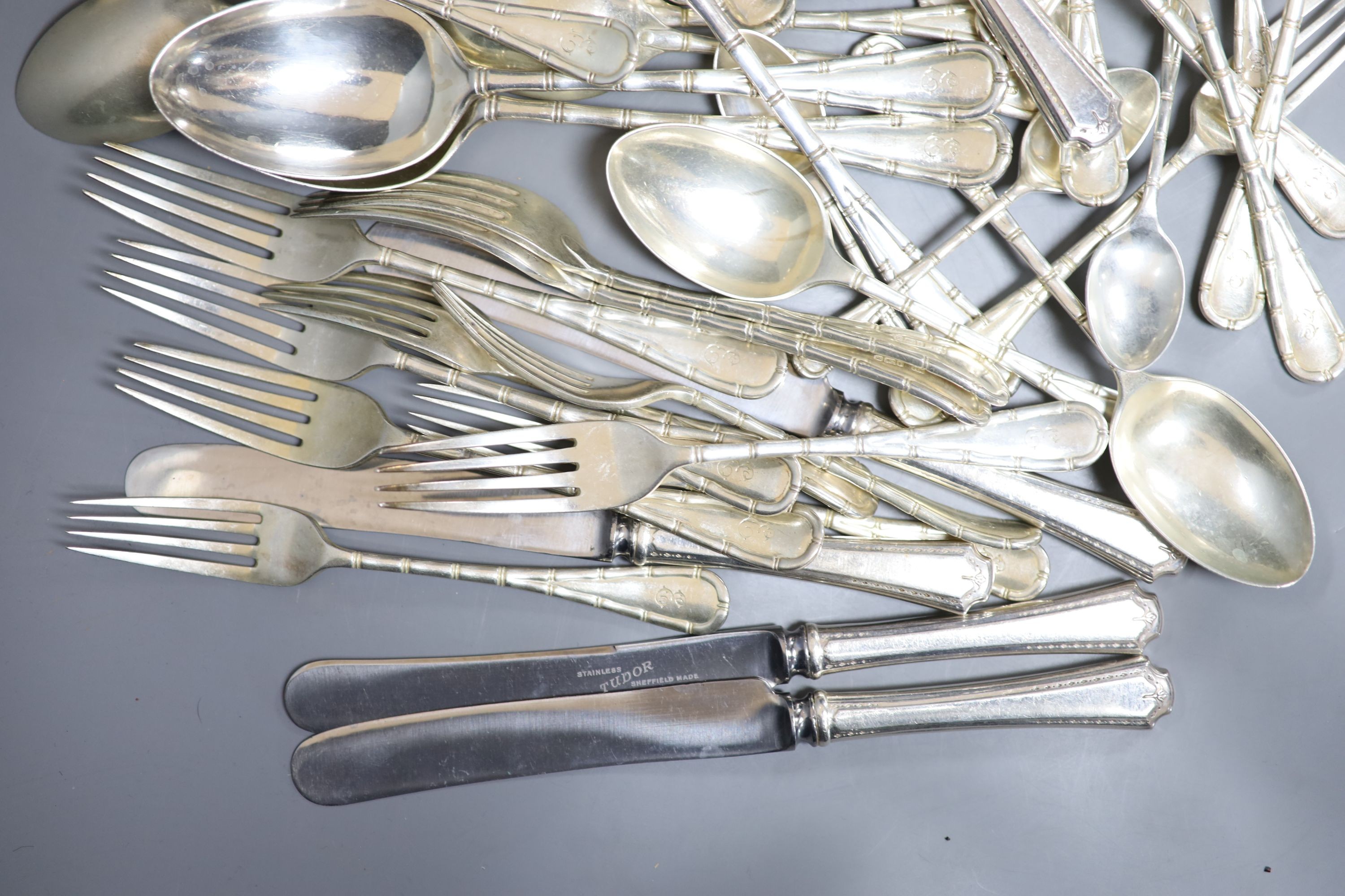 A part canteen of Edwardian silver cutlery by Atkin Brothers, Sheffield, 1903, with engraved initial, comprising forty nine items, 108oz, together with twelve later associated silver plated handled steel table knives.